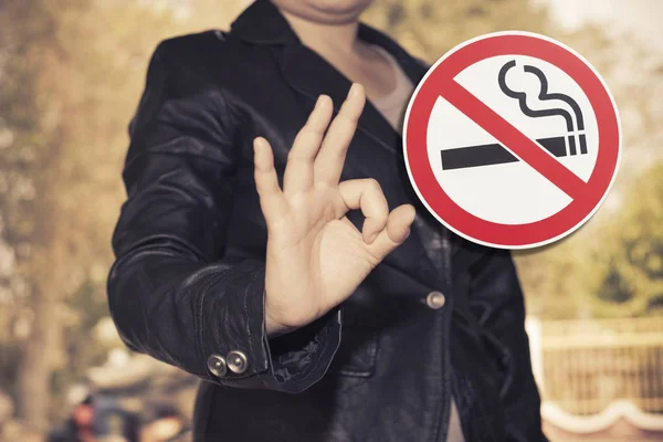 Human show OK sign with No smoking sign on color background ,hea