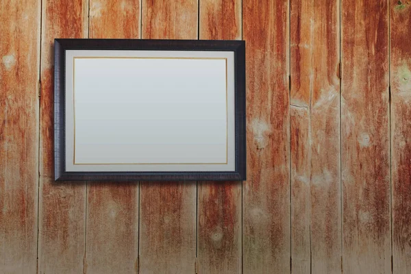Vintage picture frame on wood wall background. — Stock Photo, Image