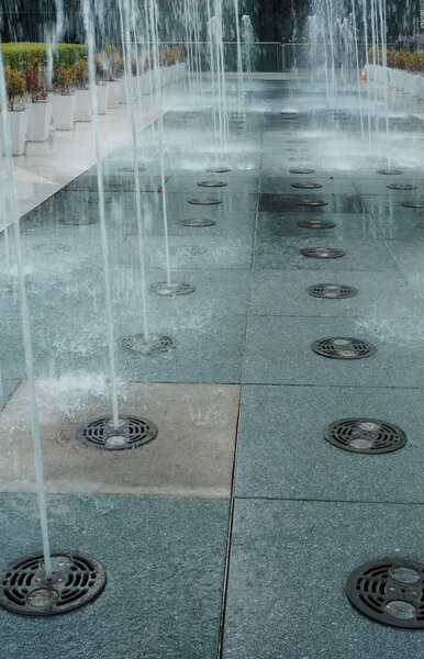 Fountain on the sidewalk or street ,park out door.