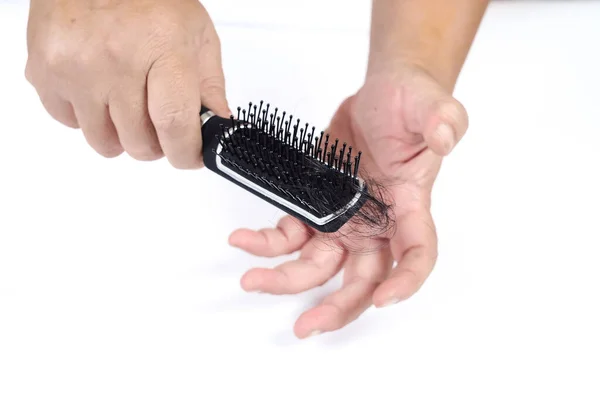 Comb with hair loss in hand on white background ,health beauty c — ストック写真
