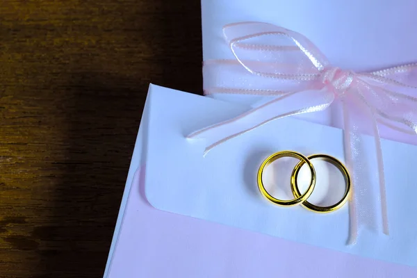 Duo anel de casamento dourado sobre invice card na mesa de madeira.Casamento c — Fotografia de Stock