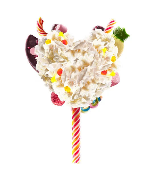 Sweet Lolipop in Heart form of whipped cream with sweets, jellies, heart front view. Crazy freakshake food trend. Front view of whipped heart of cream lolly, full of berry and jelly sweets, chocolate — Stock Photo, Image