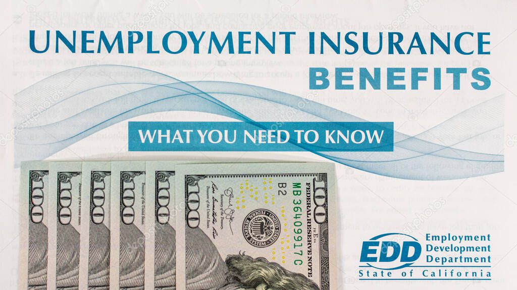 Unemployment insurance benefits booklet. Extra 600 dollars of CARES Act unemployment benefit in 100 dollar bills - San Jose, California, USA - 2020