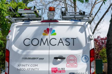 Comcast Xfinity telecommunications service van parked on the residential street near the customer home - Palo Alto, California, USA - 2020 clipart