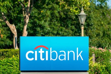 Finansal hizmetler şirketinin yerel şubesinin yanında ticari marka logosu olan bir Citibank levhası. Eski sokak lambasıyla yeşil manzara - San Jose, California, ABD - 2020