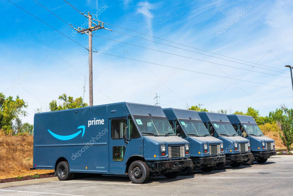 Amazon Prime delivery vans safely parked outdoor near Amazon Fulfillment Center - Newark, California, USA - 2020