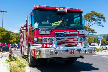 Front view of Coast Side Fire District red pumper fire engine. Patriotic flag is painted on front grill - Half Moon Bay, California, USA - 2020 clipart
