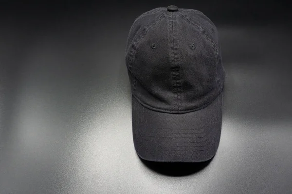Black baseball cap. Top front view, isolated on gray background