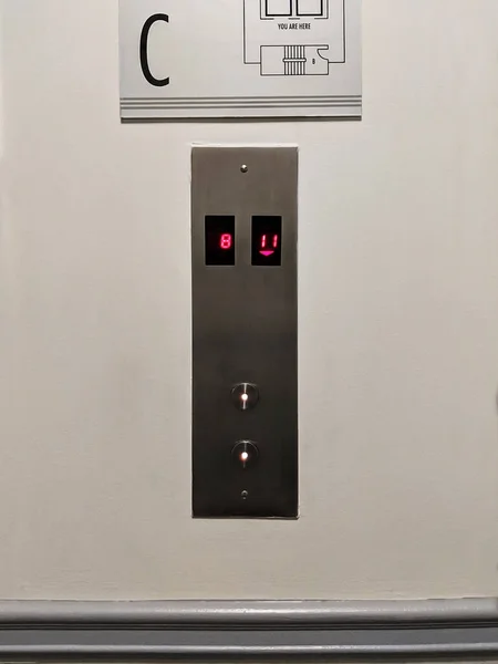Elevator buttons up and down. The modern button panel on a wall.