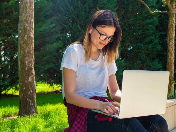 Distance learning online education. Woman with laptop outdoors. Startup business