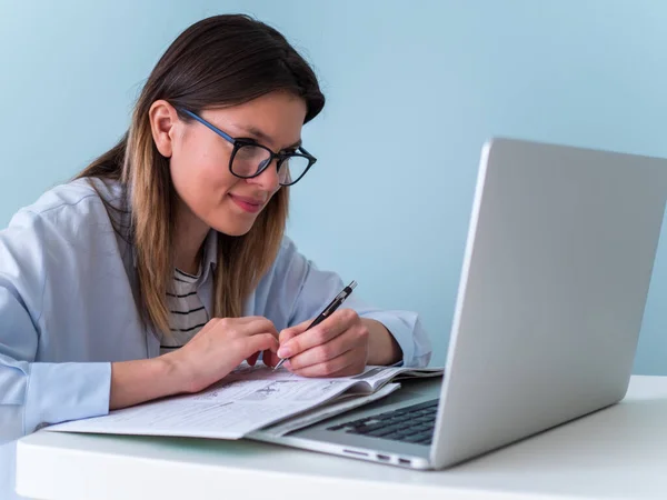 Distance learning online education. Woman studying with laptop, watching webinar video course, female caucasian student looking at laptop listening lecture study online on computer e learning