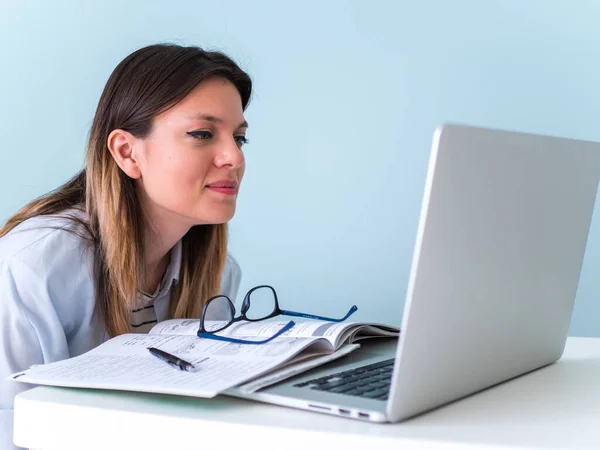 Distance learning online education. Woman studying with laptop, watching webinar video course, female caucasian student looking at laptop listening lecture study online on computer e learning