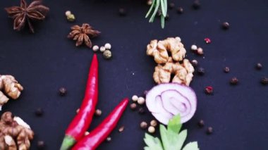 Kırmızı domatesler, biberiye, kırmızı biber ve siyah üzerine çeşitli baharatlar.