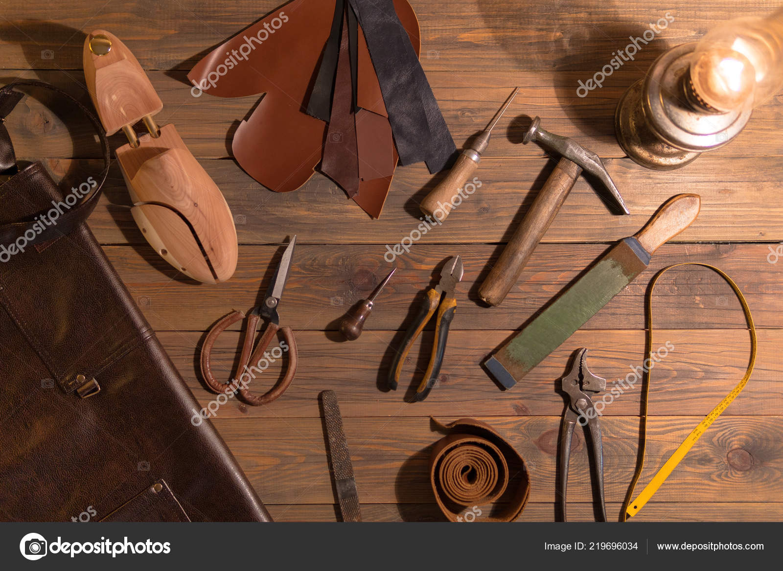 tools for making shoes lie on a wooden table. Set of items symbolizing