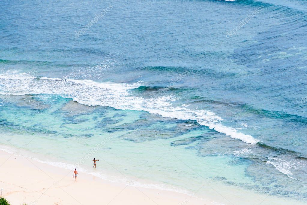 Two people on the sand beach ocean