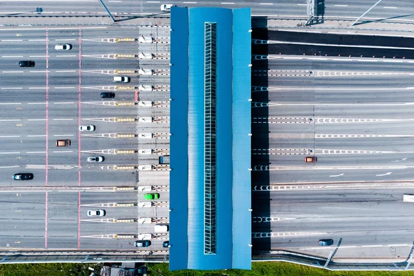 Toll roads on the broad highway. Through the point passes a large number of trucks and cars. Top down view from quadcopter