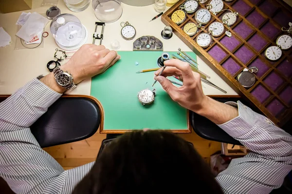 Watchmaker. Watch repair craftsman repairing watch. mans hands