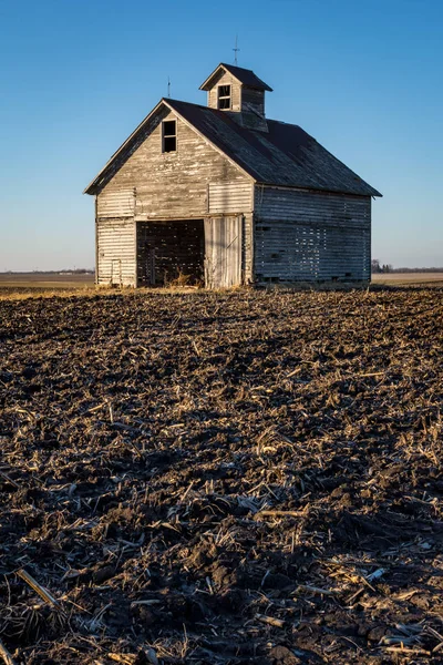Isolated midwest barn on a cold winters day approaching sunset.