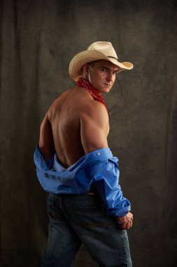The sexy man is dressed like a cowboy. clipart