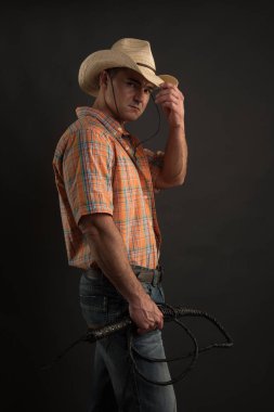 The handsome rancher poses for the camera. clipart