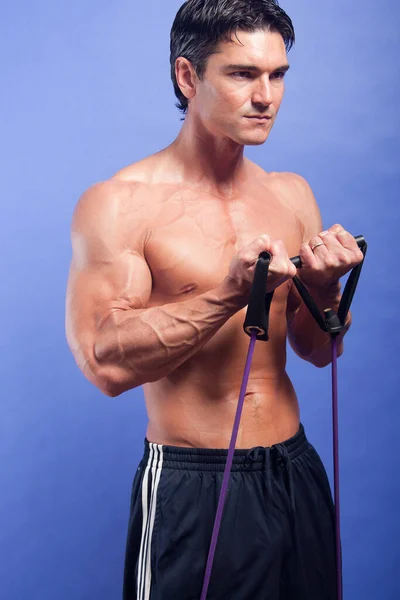 The hot guy works out his muscles.