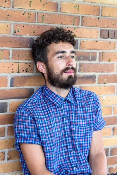 Thoughtful Young Bearded Man Sitting His Head Resting Brick Wall — Stock Photo, Image