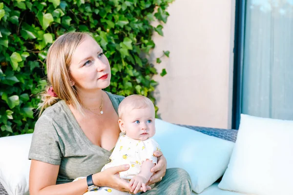 Jeune Mère Tenant Fille Bébé Assis Dans Canapé Blanc Extérieur — Photo