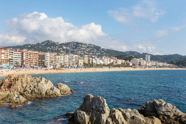 Many hotels and beach town of Lloret de Mar, Spain. People relax on the beach, bathe, swim and sunbath