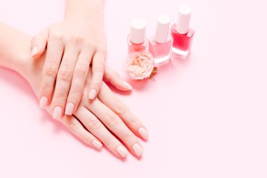 Pembe arka planda güzel manikürlü kadın elleri. Hands spa konsepti