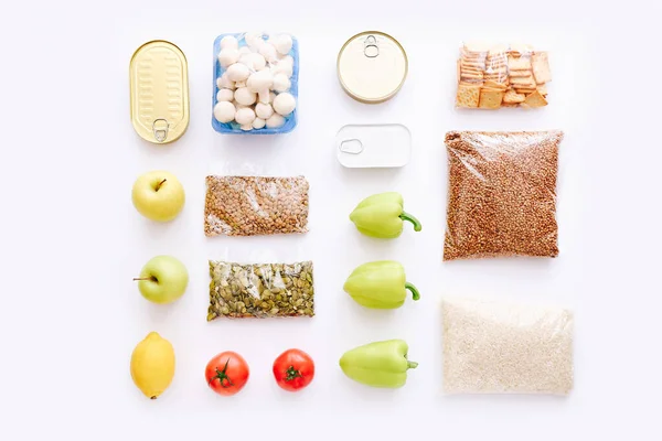 Set of grocery items from canned food, vegetables, cereal on white background. Food delivery concept. Donation concept. Top view. — Stock Photo, Image