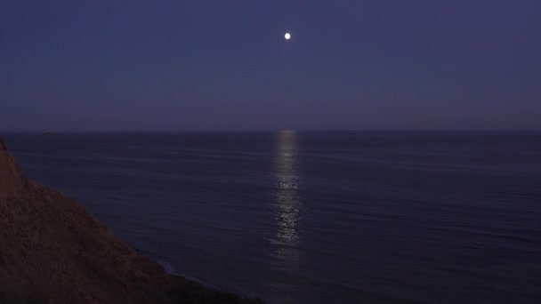 La luna llena ilumina la superficie del agua. Pista lunar en la superficie del agua. — Vídeo de stock