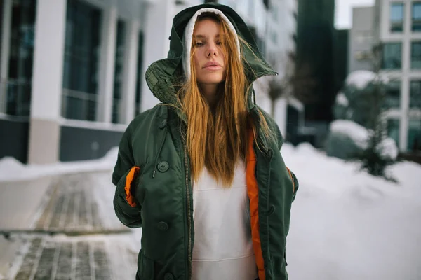 Picture of blond model in hood and in jacket against winter day — Stock Photo, Image