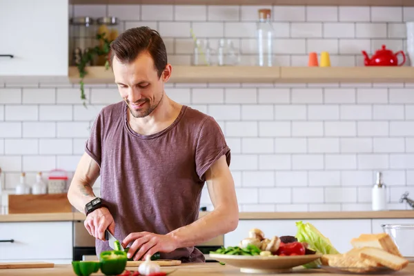 Picture of man cooking vegetables on table