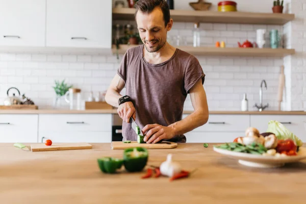 Picture of man cooking vegetables on table