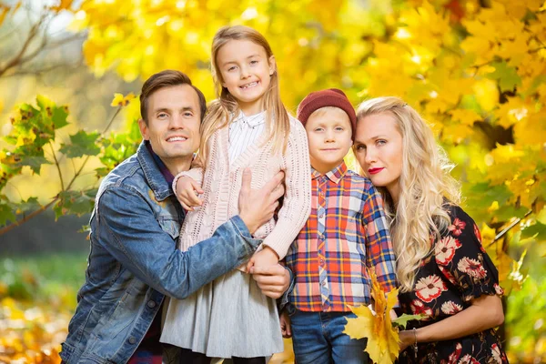 Photo of young family with children on walk in autumn park — Stock Photo, Image