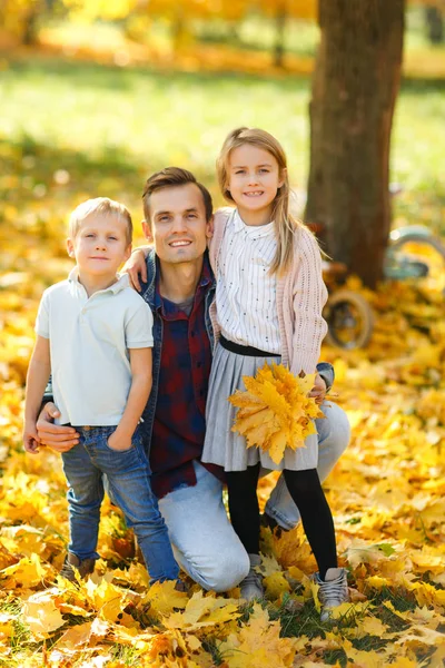 Image of happy father with daughter and son in autumn park walking — Stock Photo, Image
