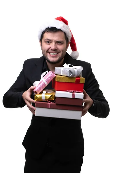 Foto van gelukkig man in kerstmuts met dozen met geschenken in handen — Stockfoto