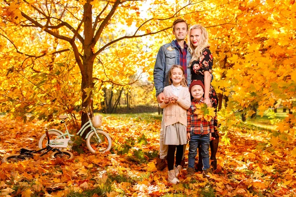 Image of young parents and children on walk in autumn park — Stock Photo, Image