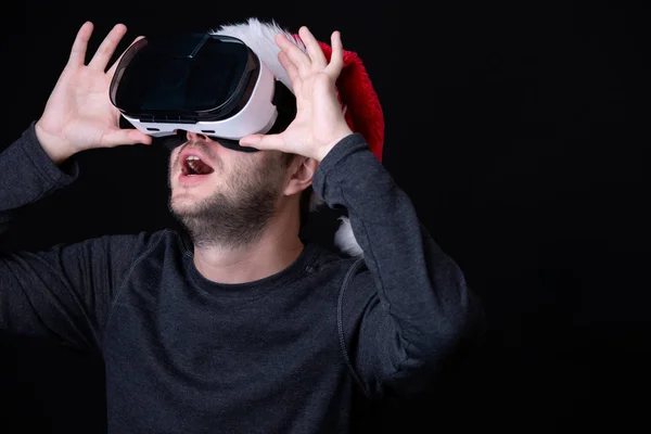 Photo of man in Santas cap and glasses of virtual reality — Stock Photo, Image