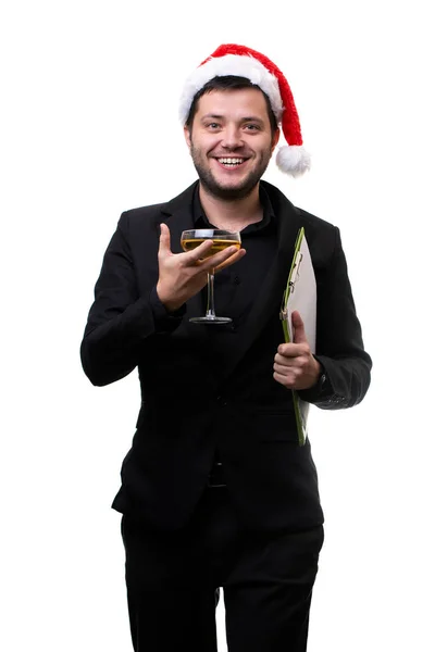 Imagen de la morena en gorra de Santas, con copa de champán, carpeta con hoja en blanco en las manos . — Foto de Stock