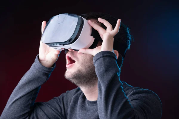 Photo of surprised young brunet in virtual reality glasses — Stock Photo, Image