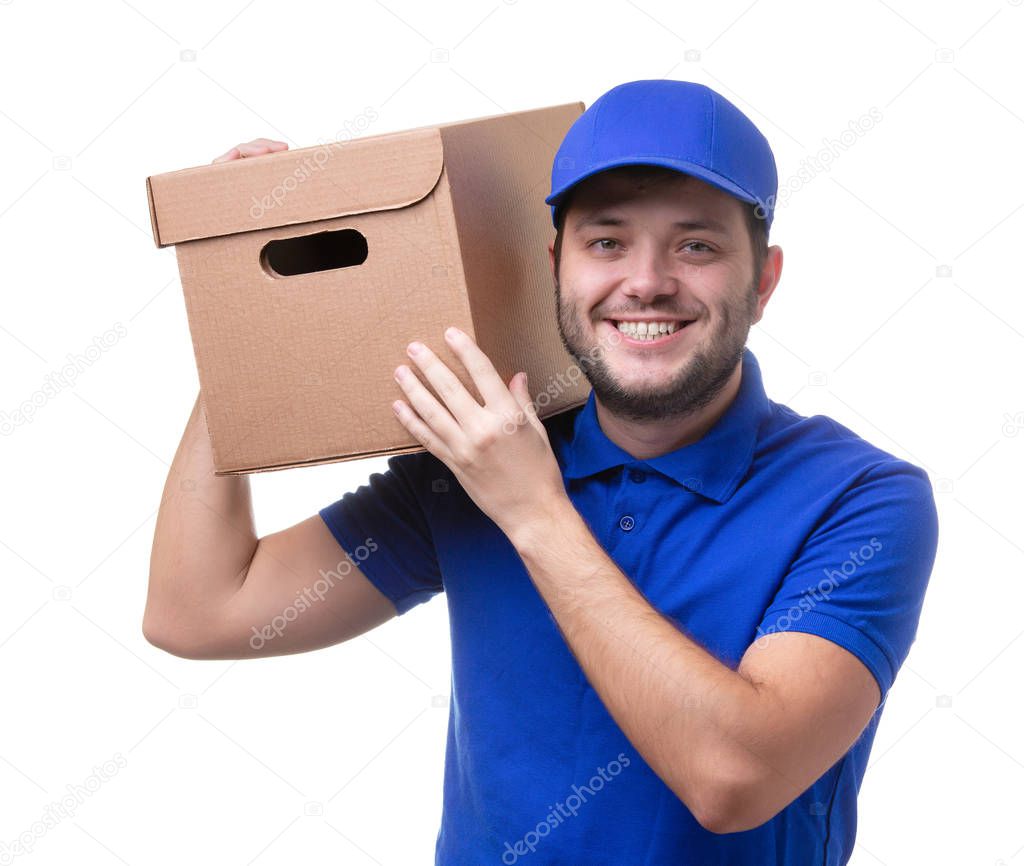 Picture of man in blue T-shirt and baseball cap with cardboard box on shoulder standing