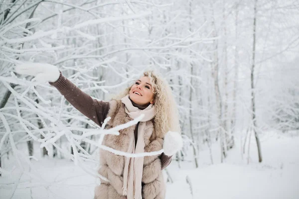 Φωτογραφία: ξανθιά γυναίκα για βόλτα στο δάσος του χειμώνα — Φωτογραφία Αρχείου