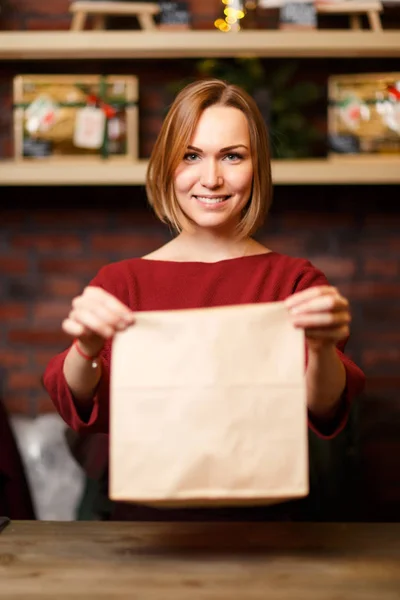 Φωτογραφία του πωλητή κορίτσι με χαρτί τσάντα — Φωτογραφία Αρχείου