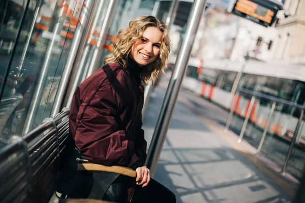 Foto der Blondine sitzt auf Bank in der Stadt — Stockfoto