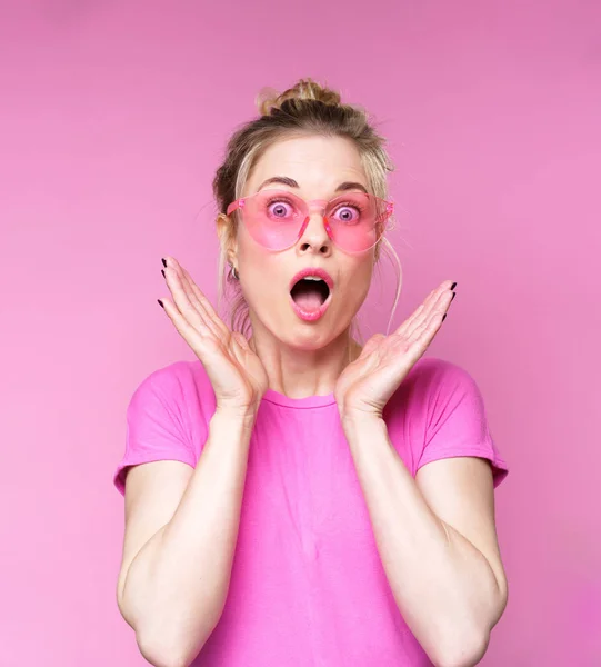Изображение удивленной блондинки в розовых очках в футболке — стоковое фото