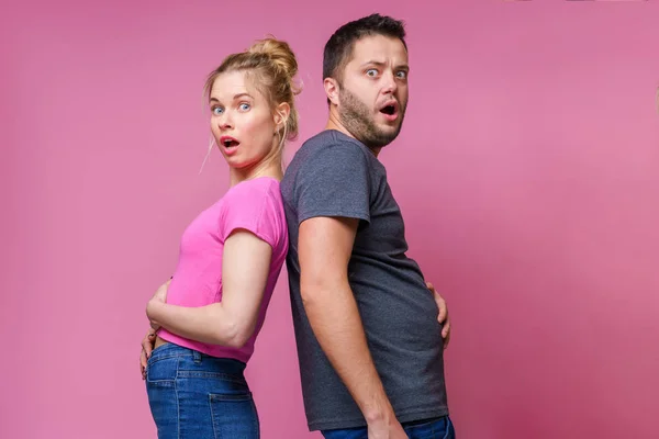 Photo back to back gorged women and men — Stock Photo, Image