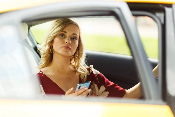Photo of young blonde sitting in taxi. — Stock Photo, Image