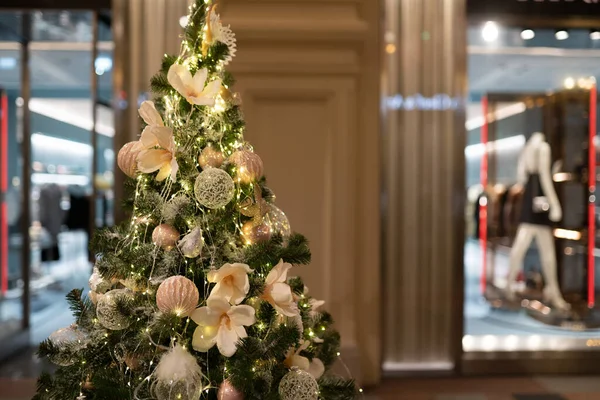 Image of decorated Christmas fir on blurred background.
