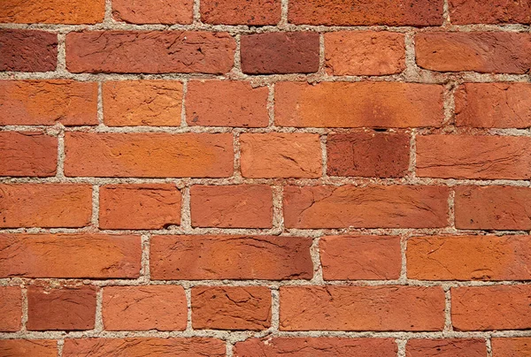 The wall of the building is made of old red brick. Background for text, posters. The brick is destroyed, the brick crumbles. Lots of bricks in the background. Background. Copy space. — Stock Photo, Image